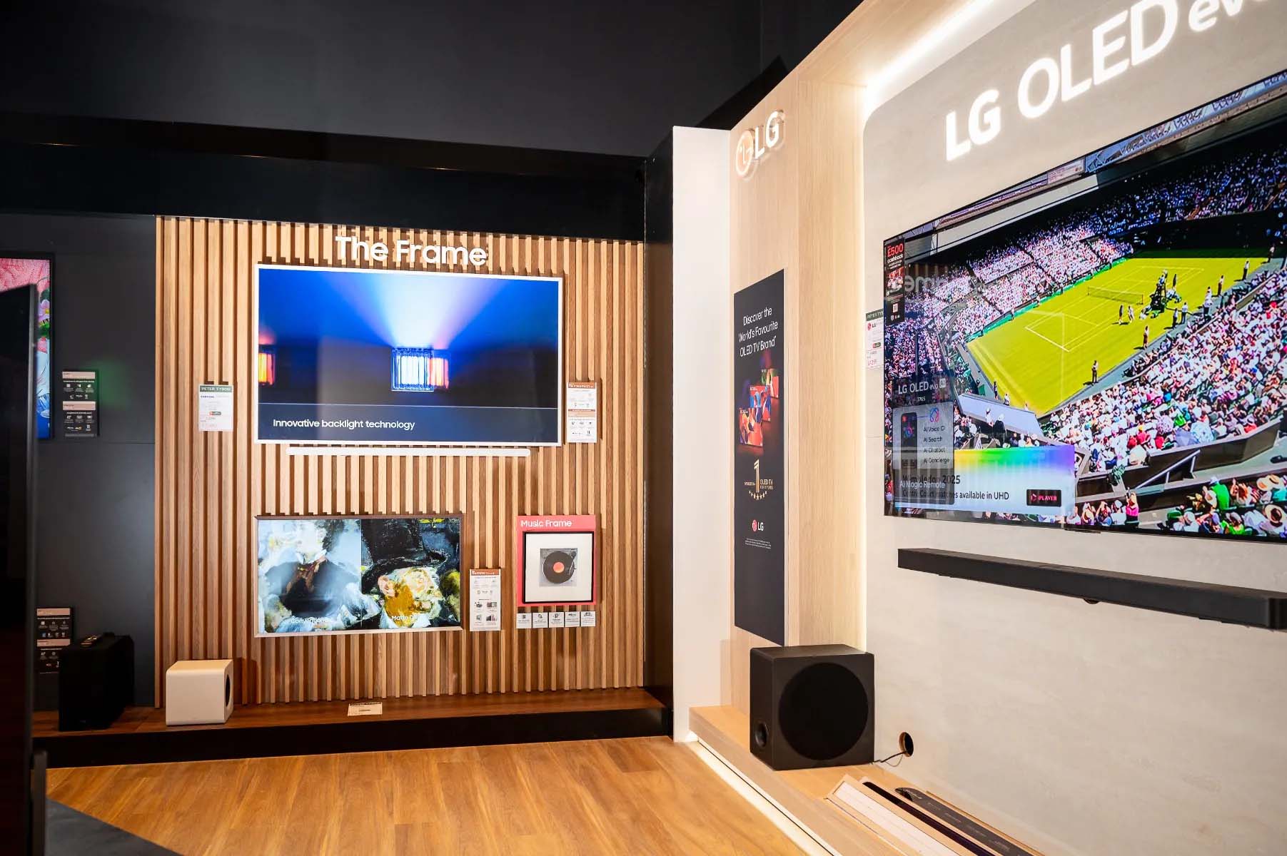 Modern showroom featuring "The Frame" TV with sleek design and innovative backlight technology, and LG OLED TV displaying a vibrant tennis match.