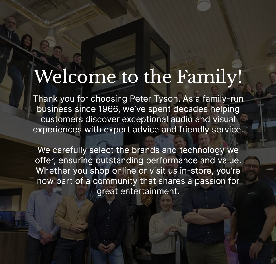 Group photo of the Peter Tyson family-run team standing inside a modern electronics showroom, under a overlay message reading "Welcome to the Family!" and thanking customers for choosing their business for audio and visual experiences.