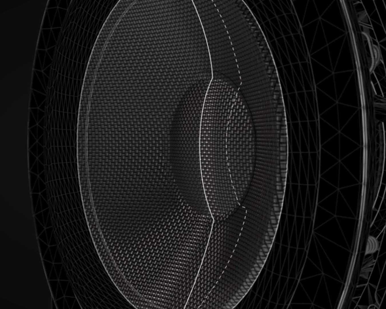 Close-up of a black textured speaker cone with intricate geometric patterns, highlighting the woven surface and metallic accents against a dark background.