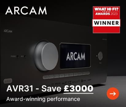 Arcam promotional banner advertising a major discount on the AVR31 receiver with the text "AVR31 - Save £3000" and the tagline "Award-winning performance". The banner displays a close-up, front-facing view of the premium black audio-video receiver, showcasing its oversized silver volume knob and a digital display screen illuminated with the white Arcam logo. The prominent white Arcam brand name sits at the top left, a red "What Hi-Fi? Awards 2023 Winner" logo is placed at the top right, and an orange circular button with a white arrow is positioned in the bottom right corner.