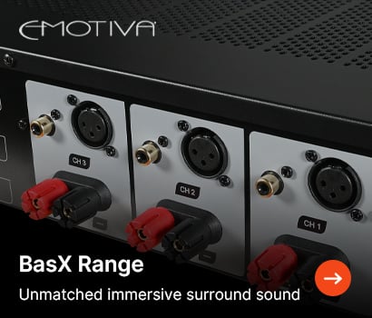 Emotiva promotional banner for the BasX Range power amplifier featuring the headline "BasX Range" and subtext "Unmatched immersive surround sound". The banner shows a close-up, angled view of the rear connectivity panel of a black audio component, highlighting three distinct channel modules labeled CH 1, CH 2, and CH 3. Each channel panel contains a gold-plated RCA input, a balanced XLR input, and a pair of red and black binding post speaker terminals. The prominent white Emotiva brand logo is positioned at the top left, and an orange circular action button with a white right-pointing arrow sits at the bottom right corner.