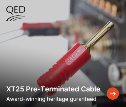 QED promotional banner for the XT25 Pre-Terminated Cable featuring the headline "XT25 Pre-Terminated Cable" and subtext "Award-winning heritage guaranteed". The image highlights a close-up view of a gold-plated 4mm banana plug with a red plastic QED branded barrel housing. In the softly blurred background, more cables are shown connected to the rear terminal binding posts of an audio component. The black QED brand logo sits in the top-left corner against a light grey gradient background, and a bright orange circular action button with a white right-pointing arrow is positioned at the bottom right.