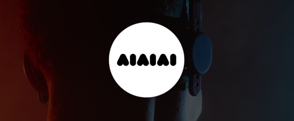 A person wearing headphones is shown from behind, with a rich gradient background of red to blue. A circular logo with the word "AIAIAI" appears on the left.