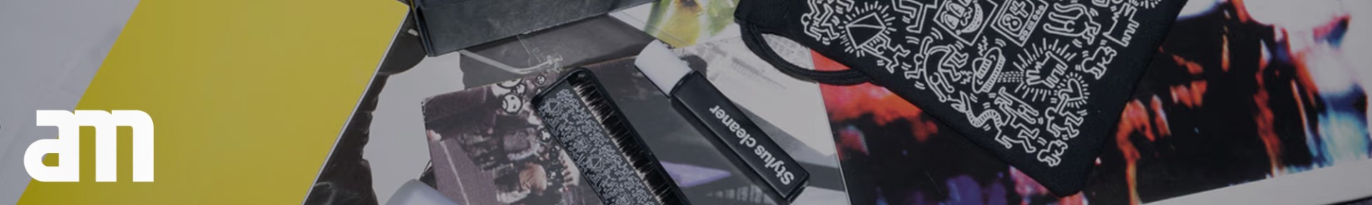 A collage of colourful images and objects featuring a black pouch with white abstract designs, a stylus cleaner, and a prominent yellow rectangle.