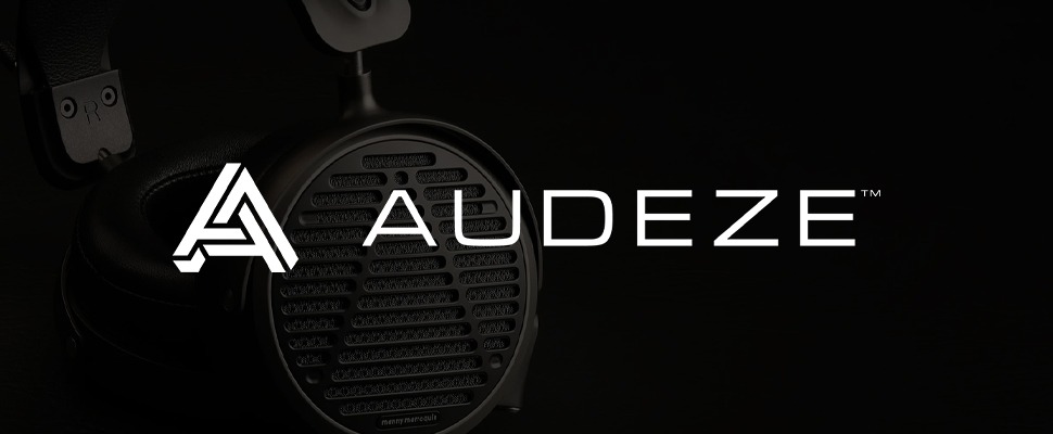 Close-up of a sleek, black Audeze headphone with a mesh grill. The logo "AUDEZE" is prominently displayed on the right against a black background.
