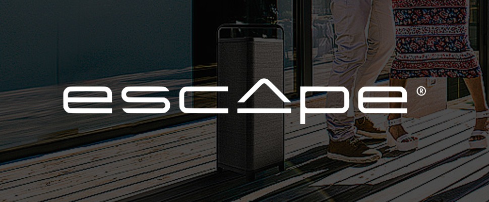 Stylish black speaker on a deck near water with people relaxing and playing. The word "escape" is prominently displayed in white text.