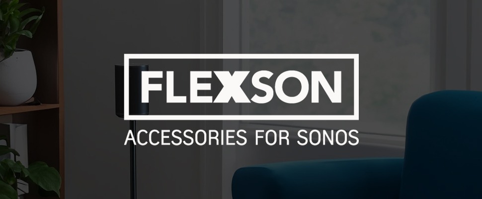 Cosy living room with a sleek black speaker on a stand, wooden shelf with plants, and modern décor. Text reads, “Flexson Accessories for Sonos.”