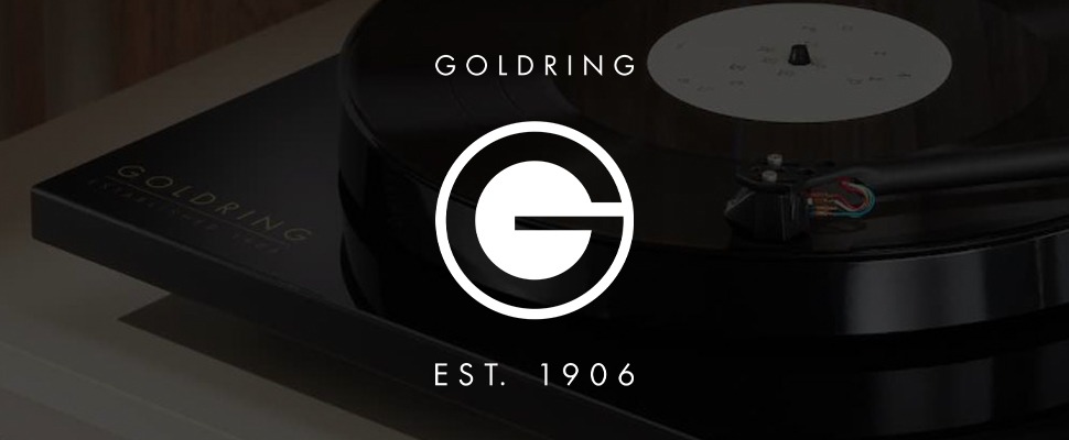 Turntable close-up: A black vinyl record spins on a sleek, modern turntable. The Goldring logo, with "Est. 1906," is visible.