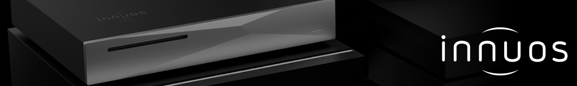 Sleek black audio device with geometric design on the front, featuring a slim slot and a subtle blue indicator. The "innuos" logo is prominently displayed.
