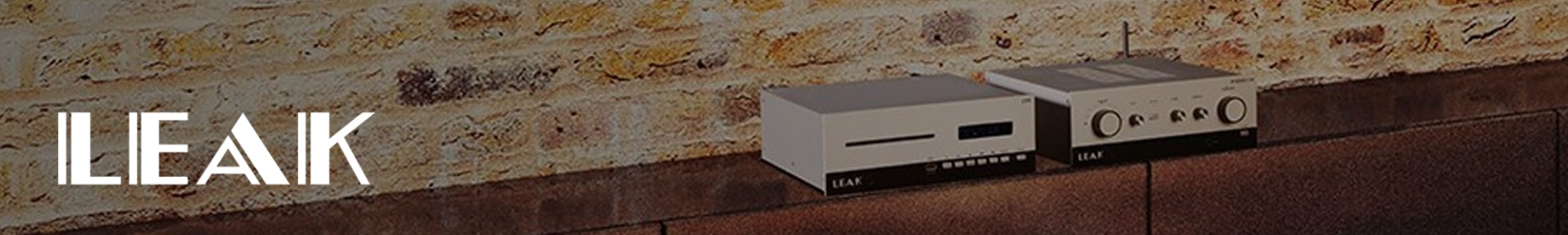 Retro-style audio equipment sits on a wooden shelf against a rustic brick wall. The scene conveys a vintage and sophisticated ambiance.