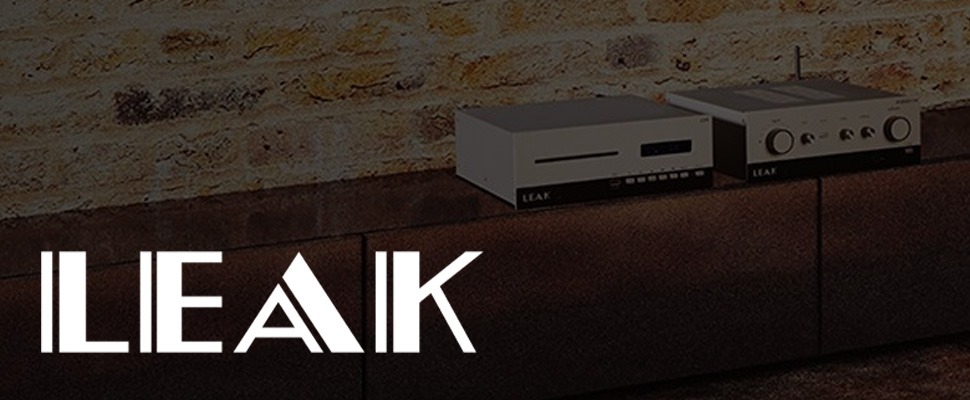 Retro-style audio equipment sits on a wooden shelf against a rustic brick wall. The scene conveys a vintage and sophisticated ambiance.