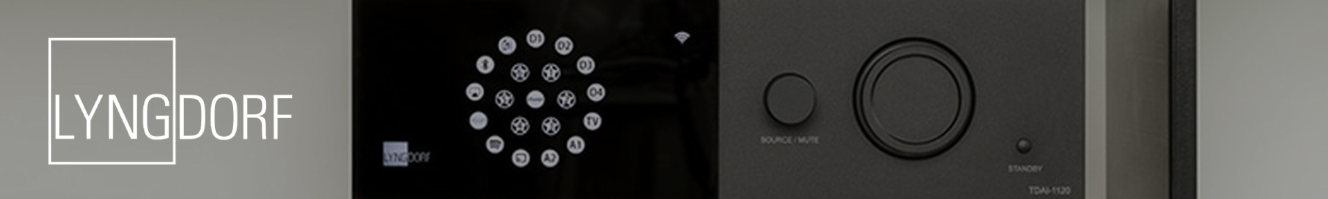 Close-up of a sleek audio device featuring a circular button layout on a black panel. The word "Lyngdorf" appears on the left. Modern and minimalistic design.