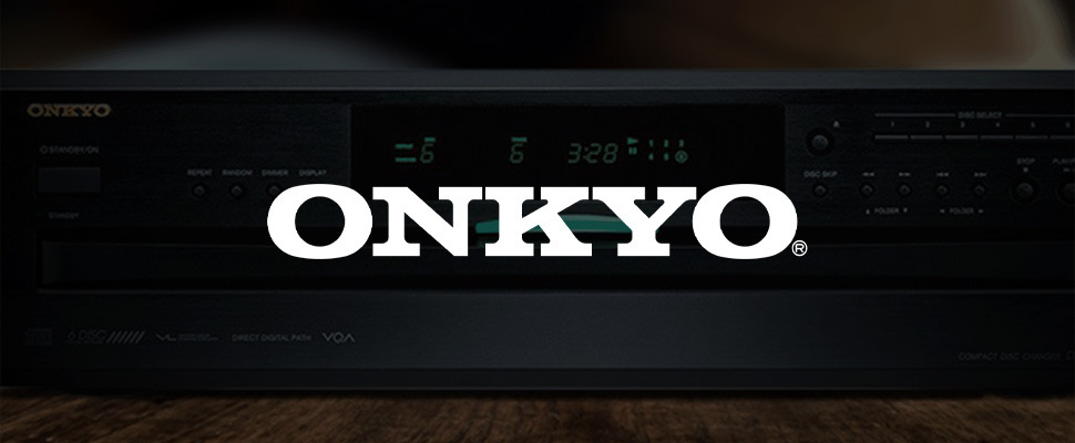 Close-up of an Onkyo audio system with a digital display showing "3:28." It has control buttons and a sleek black design, conveying a modern, sophisticated feel.