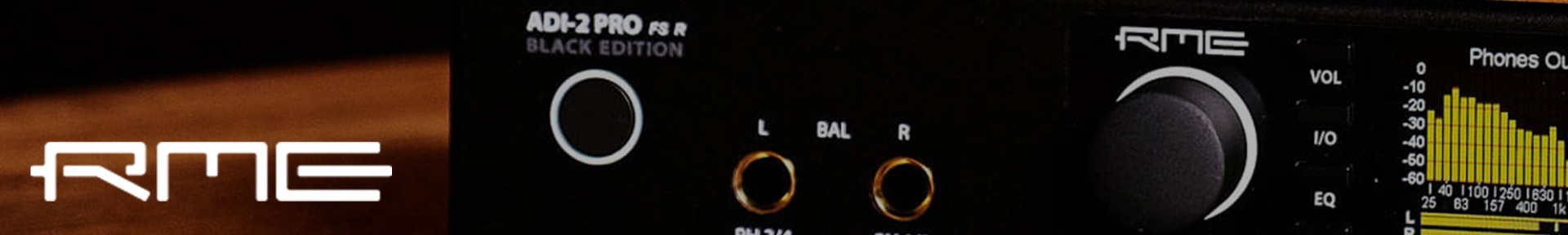 Close-up of an RME ADI-2 Pro FS R Black Edition audio interface. Shows branding, volume knob, and audio levels display. Modern and sleek design.