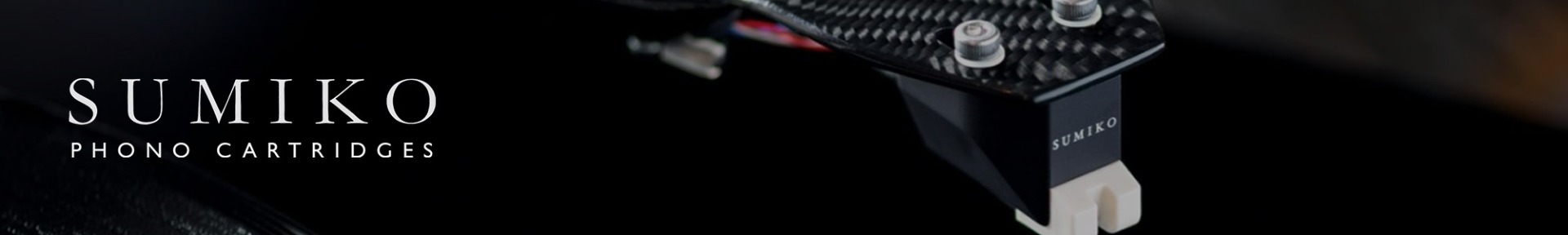 Close-up of a sleek black phono cartridge with textured finish and "Sumiko" text, set against a dark background. Modern and sophisticated design.