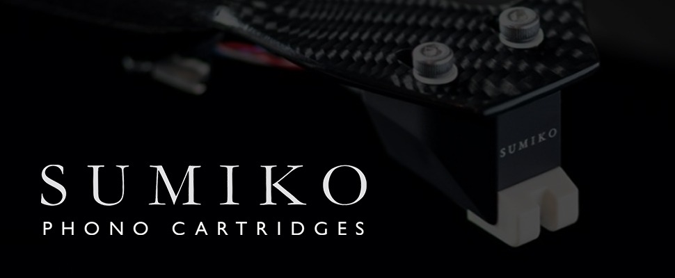 Close-up of a sleek black phono cartridge with textured finish and "Sumiko" text, set against a dark background. Modern and sophisticated design.