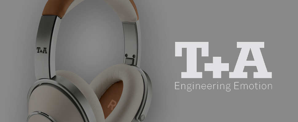 Close-up of stylish headphones with a metal finish and soft ear pads on the right; "T+A Engineering Emotion" text in white on a grey background to the left.