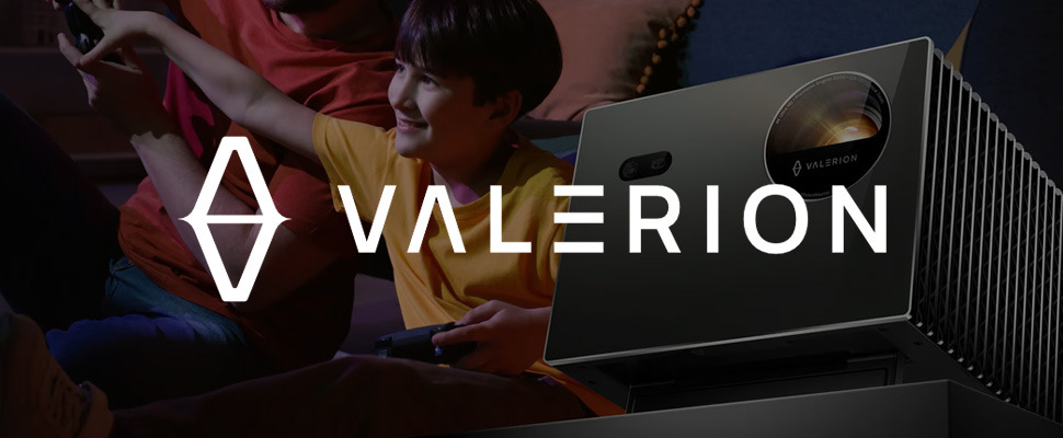 A child smiles while watching a projection, sitting beside an adult. A Valerion projector emits soft light. The brand logo is prominently displayed on the left.