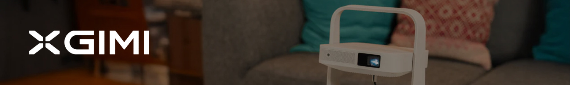 Stylish white projector on a stand in a cozy living room, with blue and red patterned pillows on a sofa. "XGIMI" logo on the left in white text.
