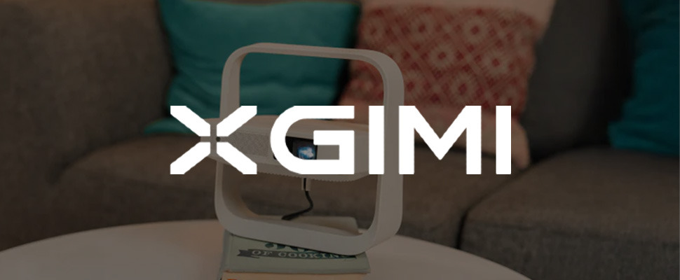 Stylish white projector on a stand in a cozy living room, with blue and red patterned pillows on a sofa. "XGIMI" logo on the left in white text.