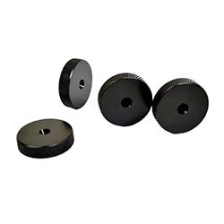 Four black thumb nuts with textured edges are scattered. Each has a central hole, arranged against a white background, conveying a mechanical theme.