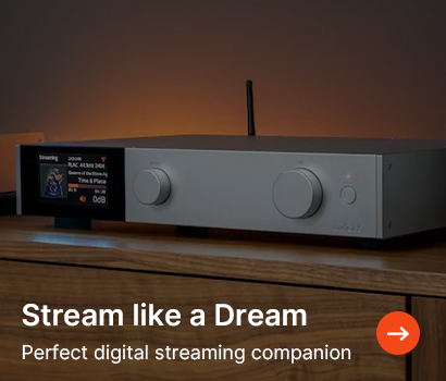 Sleek silver digital streaming device on a wooden surface, with a small screen displaying song information. Text reads: "Stream like a Dream, Perfect digital streaming companion."