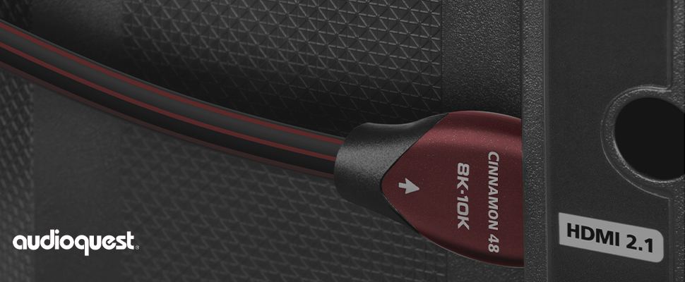 Close-up of an AudioQuest Cinnamon 8K HDMI cable, showing its red and black connector against a textured surface. 