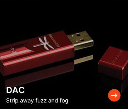 Red USB DAC with a dragonfly logo and detached cap on a reflective black surface. Text reads, “DAC - Strip away fuzz and fog,” with an arrow icon.