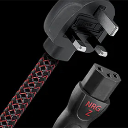 UK plug with woven black and red power cord next to a connector labelled "NRG Z," shown on a black background, conveying a modern, high-tech feel.