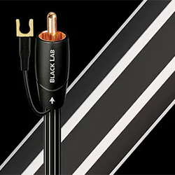 Black audio cable labelled "Black Lab" with a copper connector and a spade terminal against a sleek, diagonal black and white striped background.