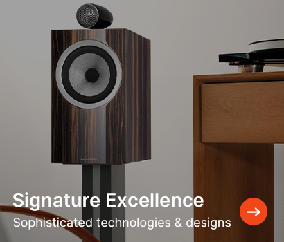 A sleek, wood-finish speaker with a modern design stands near a table. Text reads "Signature Excellence: Sophisticated technologies & designs."