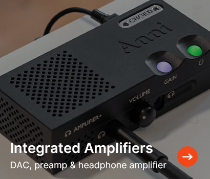 Integrated amplifier on a table, featuring volume and gain controls with purple and green indicator lights. Text reads "Integrated Amplifiers."