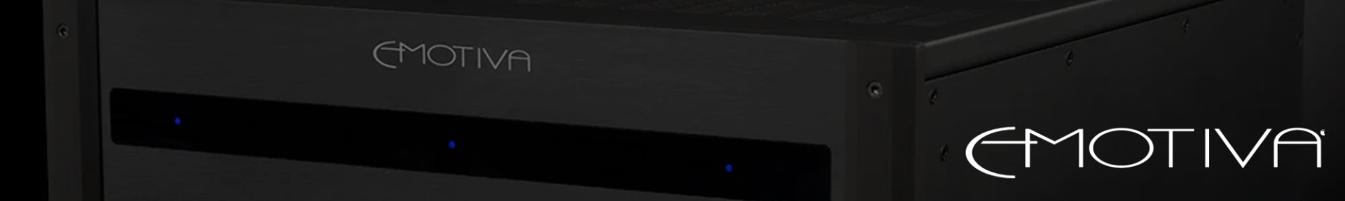 Close-up of a black Emotiva audio amplifier with a sleek design, featuring the brand's logo in white and subtle blue indicator lights on the front.