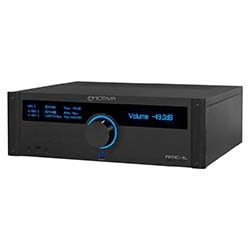Black audio receiver with a blue-lit digital display and volume knob. The screen shows "Volume: -39.0" with text and buttons on the left side. Modern and sleek design.