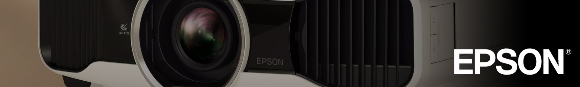 Close-up of an Epson projector lens with the brand's logo visible on the right. The image highlights the sleek design and advanced technology.