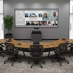 A modern conference room with a curved wooden table, empty chairs, and a large screen displaying a virtual meeting. A potted plant is on the left, creating a professional atmosphere.