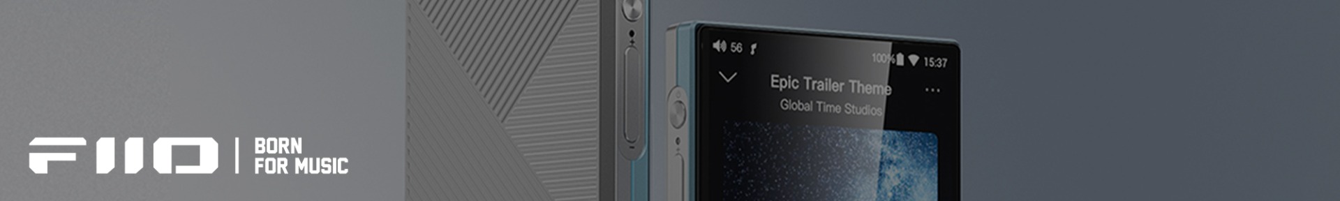 Close-up of a portable audio player with a textured grey back and a screen displaying "Epic Trailer Theme." The words "FiiO | Born for Music" are visible.