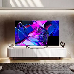 A modern living room with a large flat-screen TV on a sleek white stand, displaying abstract purple and blue shapes. Soft lighting creates a cozy atmosphere.