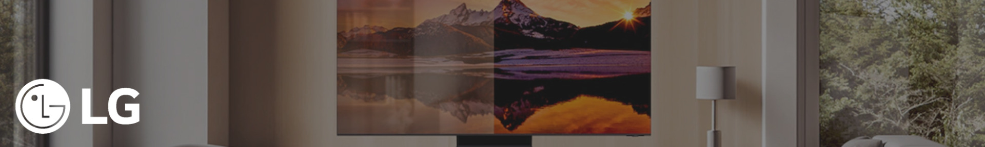 A sleek LG TV displays a vibrant sunset over a mountain lake, creating a cosy, modern living room vibe. Natural light filters through nearby windows.