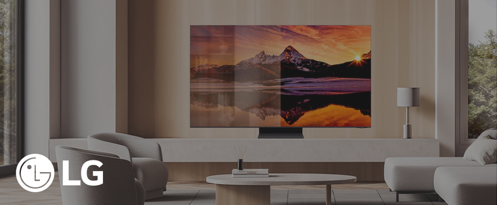 A sleek LG TV displays a vibrant sunset over a mountain lake, creating a cosy, modern living room vibe. Natural light filters through nearby windows.