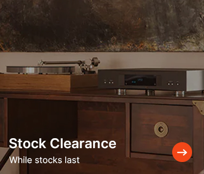 A wooden cabinet with a turntable and audio equipment on top. Text reads 'Stock Clearance, While stocks last' with an orange arrow icon.