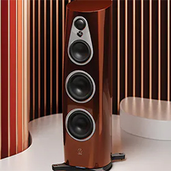 A sleek, brown floor-standing speaker with three circular drivers, set against a stylish backdrop of vertical wooden slats, conveying modern elegance.
