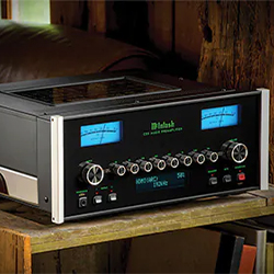 Vintage stereo amplifier with glowing blue meters and multiple dials, set on a rustic wooden shelf, creating a nostalgic, classic atmosphere.