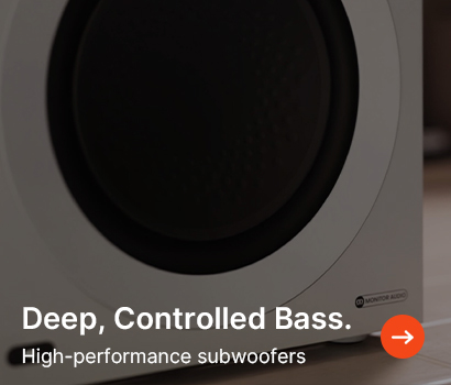 Close-up of a modern subwoofer in a sleek white casing, with text "Deep, Controlled Bass. High-performance subwoofers" and an arrow icon.