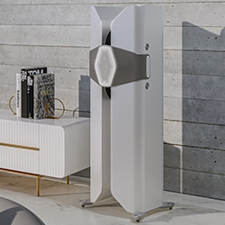 Modern white air purifier with a hexagonal design stands in a minimalist room beside a white console table and books, under soft lighting.