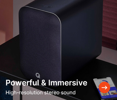 A sleek black speaker on a table, beside a smartphone. Text overlays read "Powerful & Immersive" and "High-resolution stereo sound." Arrow icon points right.