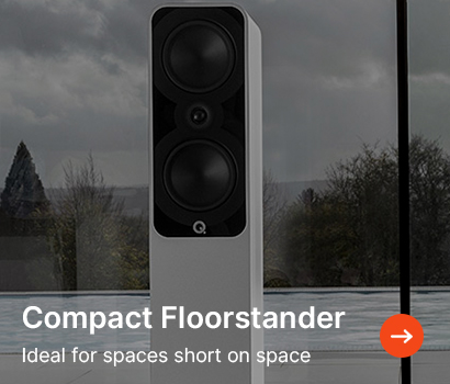 A sleek, compact floorstanding speaker with a modern design stands near a window, set against a cloudy sky and bare trees. Text reads, "Compact Floorstander: Ideal for spaces short on space."