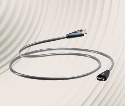 USB-C to HDMI cable on a textured, grey background. The cable is coiled artistically, conveying a modern, tech-savvy tone with sleek connectors.