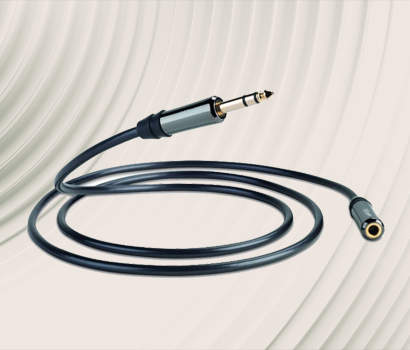 A coiled audio cable with a 3.5mm jack plug and a female adapter rests on a textured, wavy cream backdrop, conveying a sleek, modern feel.