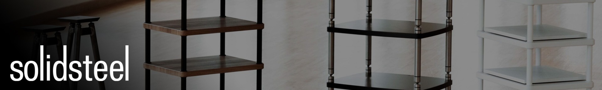 Modern audio racks in black, wood, and white are displayed against a light background. The word "solidsteel" in bold white is on the left, exuding sleek sophistication.